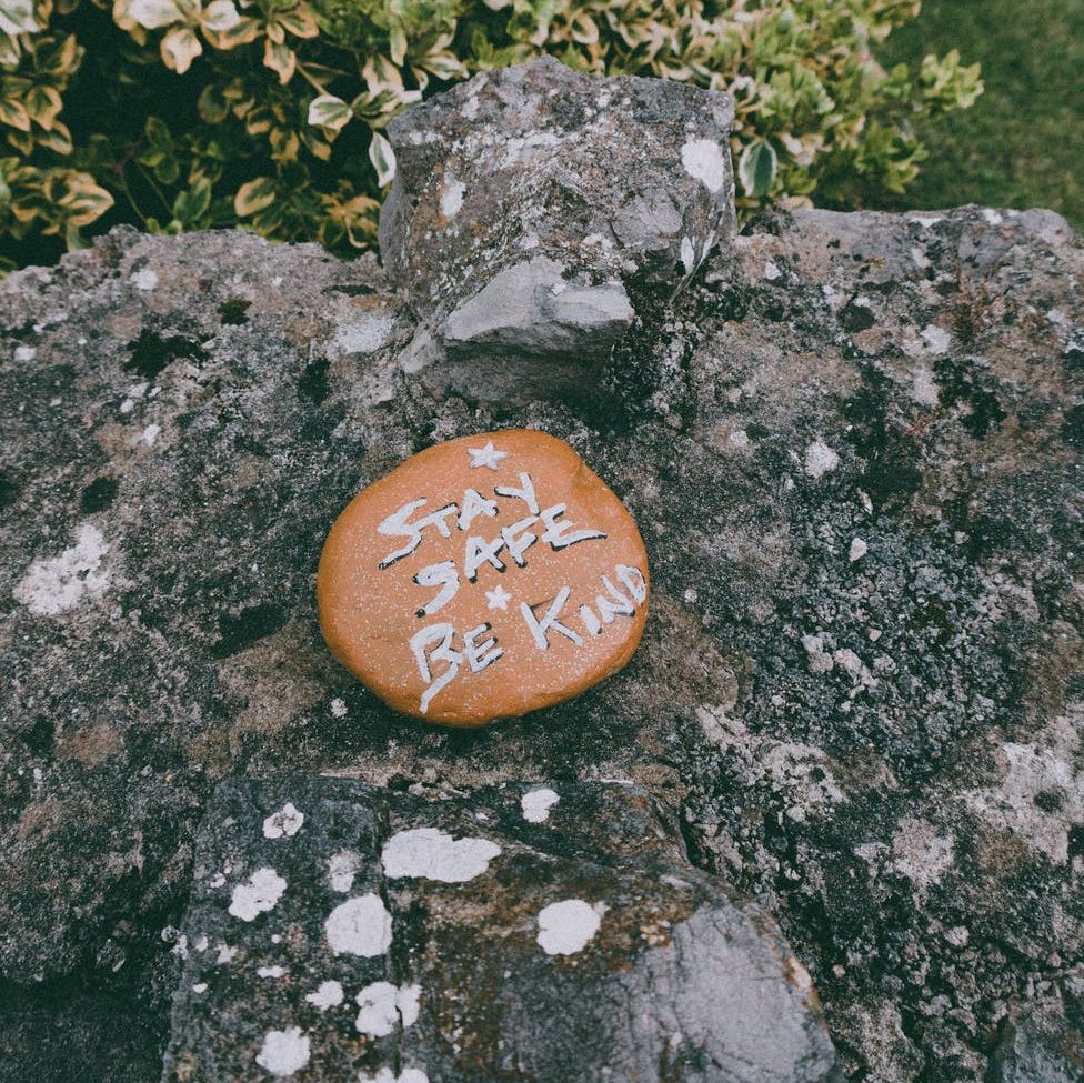 stay safe be kind inscription on stone